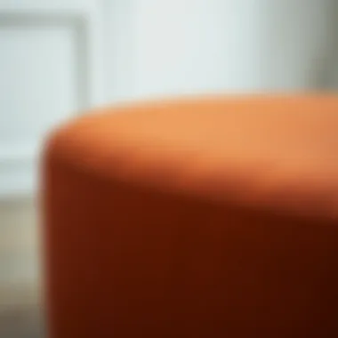 Close-up of the rust ottoman stool showcasing its material texture