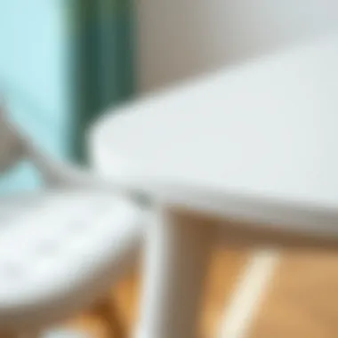Close-up of the material texture of a small white drop leaf dining table