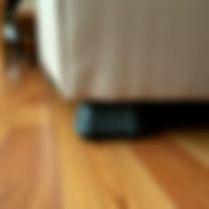 Close-up of a sofa foot protector installed on wood flooring
