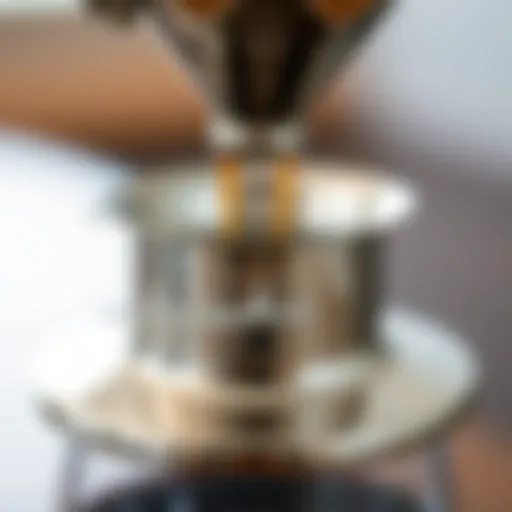 Close-up of a polished metal coffee dripper showcasing intricate design